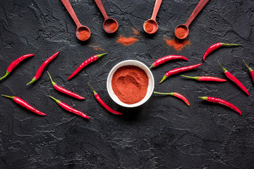 cooking sauce with red chili pepper on dark kitchen table background top view