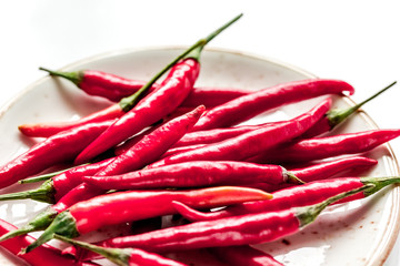 red hot chili pepper design on white table background close up