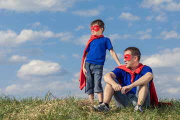 Naklejka na ściany i meble Father and son playing superhero at the day time.