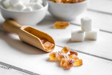 white and brown sugar for cooking sweets on kitchen white wooden table close up