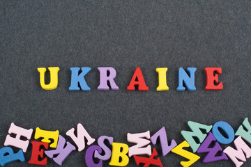 UKRAINE word on black board background composed from colorful abc alphabet block wooden letters, copy space for ad text. Learning english concept.