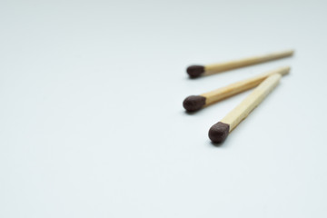 Matches over white background. Closeup shot. Shallow depth of field.