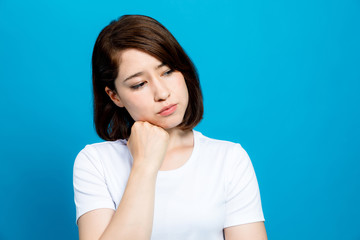 woman thinking on blue background.