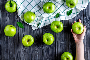 natural food design with green apples dark desk background top view