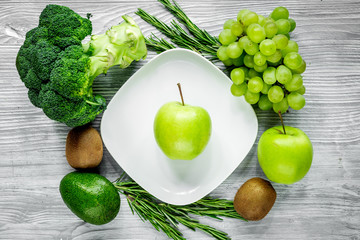 healthy green food with fresh vegetables on gray wooden table background top view