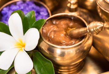 curcuma and tamarine paste in golden container, set of thai spa herb with plumeria flower