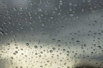 Water drop on the glass with cloud storm background