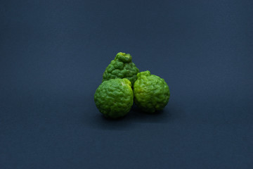 Kaffir Limes over black background. Shallow depth of field.