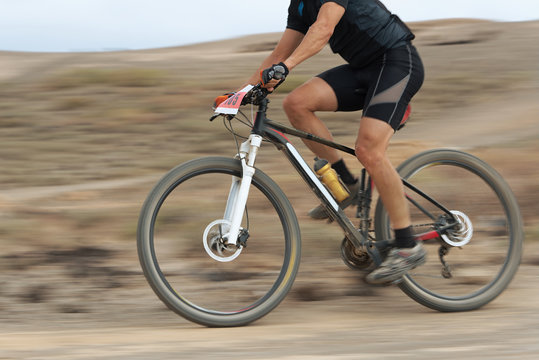 Motion blur of a mountain bike race with the bicycle and rider at high speed