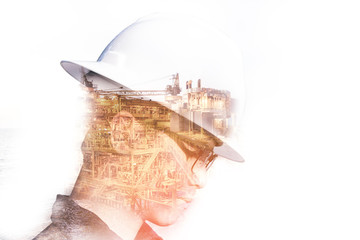 Double exposure of Engineer or Technician man with safety helmet operated platform or plant by using tablet with offshore oil and gas platform background for oil and gas business concept