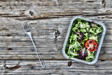 Take away the natural organic food in foil boxes. Fitness nutrition, vegetable salads