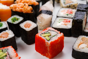 Set of sushi, maki and rolls isolated closeup with chopsticks
