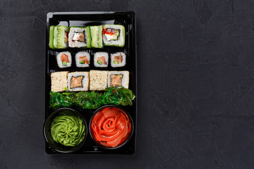 Set of sushi maki and rolls closeup in delivery box