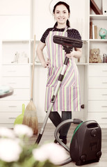 Young woman with vacuum cleaner