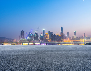 Fototapeta premium cityscape and skyline of chongqing from empty brick floor at night