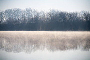 A misty dawn on the river in the early morning in the village