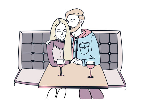 Young couple sits in a cafe and drinks wine