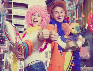 Obraz na płótnie Canvas Merry guy and girl are happy shopping