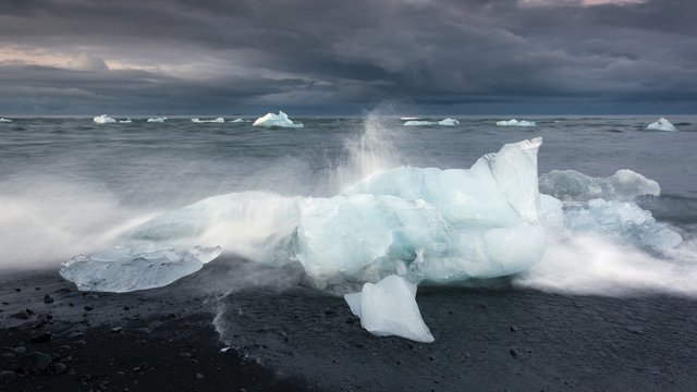 Blue iceberg on black volcanic beach, Jokulsarlon lagoon, Iceland