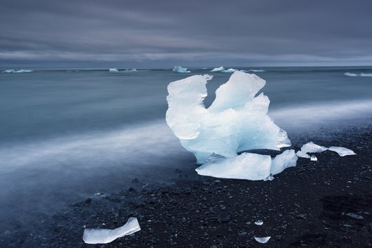 Blue iceberg on black volcanic beach, Jokulsarlon lagoon, Iceland
