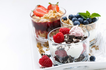 sweet desserts with fresh berries in glasses