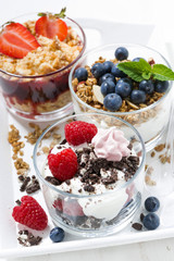 sweet desserts with fresh berries in glasses, top view closeup