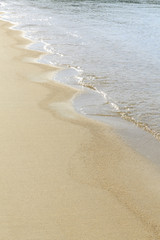 Soft sea wave on sandy beach, Beautiful Greek beach with fine sand, Close up photo of sandy beach with soft wave in motion