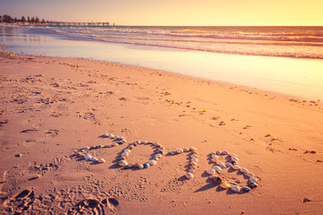 2018 New Year text on sand