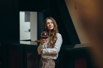 Portrait of a beautiful woman with a glass of wine in her hand