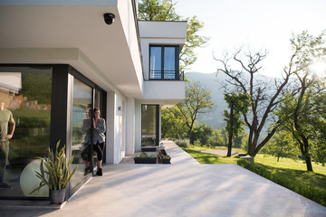 woman in front of her luxury home villa