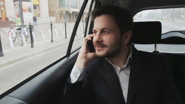 Man Talking on the Phone and Checking Hour in the Car