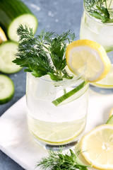 Close up Detox water with cucumber lemon and lime Cold drink Cold lemonad with vegetables and citrus fruits