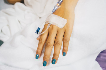Obraz na płótnie Canvas Sickness with female hand on blanket