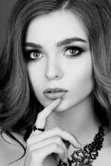 Obraz premium Beautiful model with long red wavy hair and jewelry necklace . Hairstyle small Curling