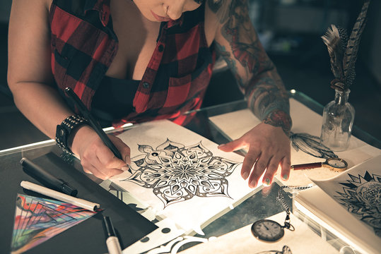 Female making illustration by pen