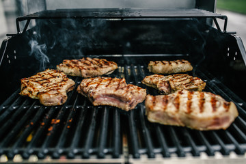 Grilled beef steak on the grill, close-up.