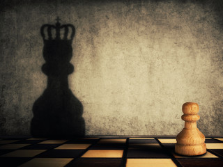 Pawn chess piece glorification, casting a shadow of coronation on a concrete wall. Business...
