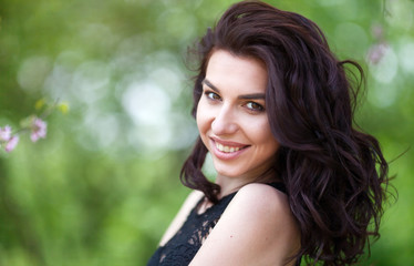 Closeup portrait of positive brunette girl. Beauty smiling model with natural make up and long eyelashes. Youth and skin care concept