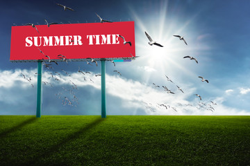 Red billboards on green field.