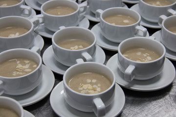 cup with creamy  soup and almond on top