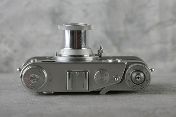 The old rangefinder camera on gray cement background.