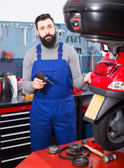 Fototapeta premium Worker repairing motorbike