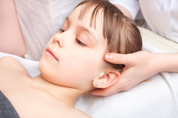 Girl receiving osteopathic treatment of her head