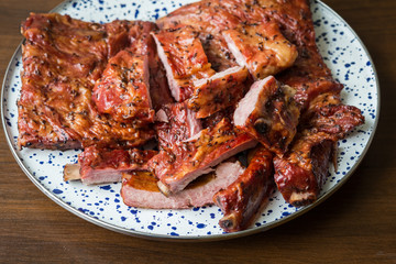 Smoked pork ribs on a decorative plate. Food and cooking.