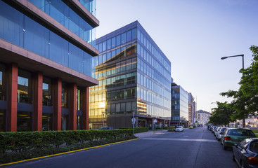 Street in Budapest with modern office buildings, sun reflections on glass windows