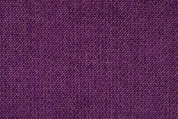 Dark purple background from woolen texture textile, closeup. Structure of the wicker fabric macro.