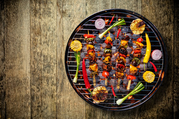 Top view of fresh meat and vegetable on grill placed on wooden floor