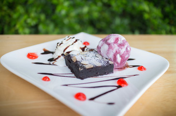 Homemade brownies with vanilla ice cream and whipped cream.(selective focus)