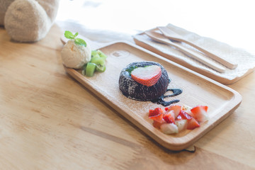chocolate lava cake with vanilla ice cream and strawberry