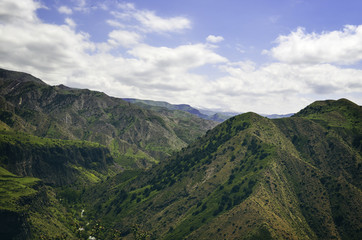 Beautiful mountain landscape, with mountain peaks covered with forest and a cloudy sky. Armenian and Georgian mountains, Caucasian mountain range